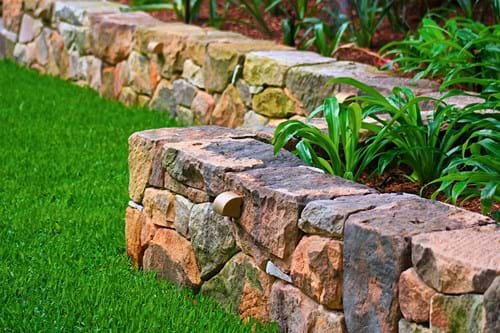 Sandstone reclaimed from original garden and hand-worked for new seat wall