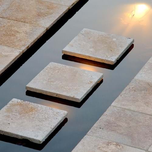 Tumbled travertine steppers across water feature