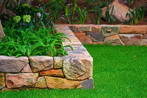 Sandstone seat wall using reclaimed site stone dug out of the old garden